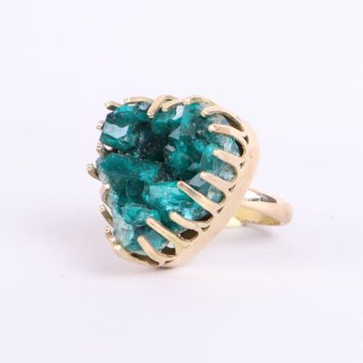 an image of a gold ring with a green tourmaline stone