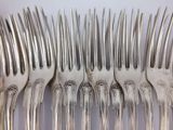 a lot of forks that are sitting on a table