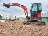 a small excavator that is sitting in the dirt
