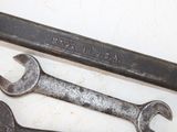 two wrenches sitting next to each other on a table