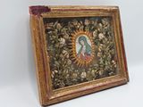 an old picture frame with a painting of a woman surrounded by flowers