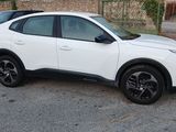 a white car that is parked in a parking lot
