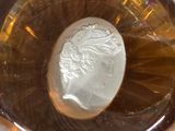 a glass with a coin in it sitting on a table