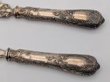 two spoons that are sitting next to each other