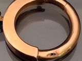 an image of a gold plated ring on a table