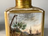 a small vase with a painting on it on a table