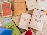 many books that are stacked together on a table