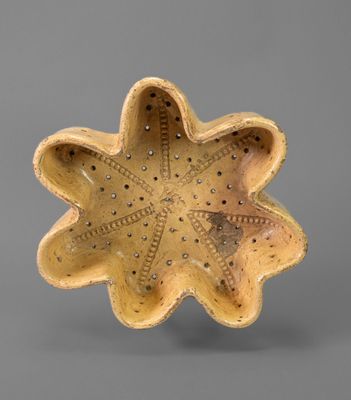 yellow ceramic bowl with a star shaped design on the inside