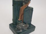 a cat sitting on a bookend with a cat on top of it