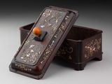 a small box with an orange ball in it