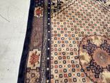 a cat that is sitting on a rug on the floor