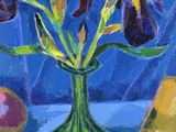 purple iriss and pears in a green vase on a blue tablecloth
