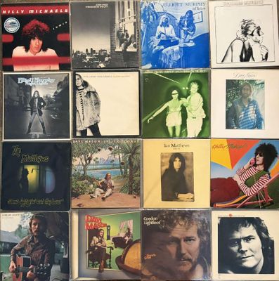 many different album covers on the table together