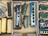 a lot of toy trains in a box on the table