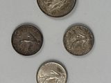 four different types of coins are shown on a white surface