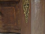 a wooden desk with a marble top and brass hardware