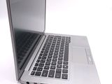 a silver laptop with a black keyboard on a white surface