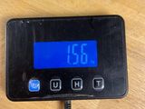 a digital clock on a table with a charger