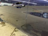 a close up of a car door handle with a sticker on it