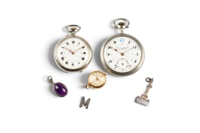 three different types of pocket watches on a white surface