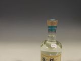 a small bottle of alcohol sitting on a table
