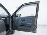 a door open of a car that is sitting on a tiled floor