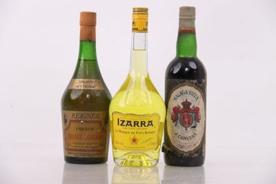 three bottles of liquor are lined up on a white surface