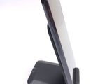 a cell phone on a stand on a white surface