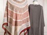 a woman standing next to a dress on a mannequin