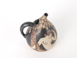 a black and white vase with a picture of a woman on it