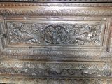 a wooden chest with carvings on the front of it