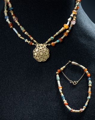 un gros plan sur un mannequin portant un collier et un bracelet