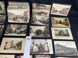 a lot of old postcards that are on a table