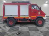 a red fire truck that is parked in a room