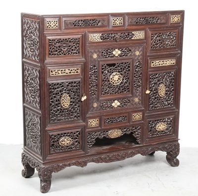 an image of a wooden chest of drawers with intricate carvings