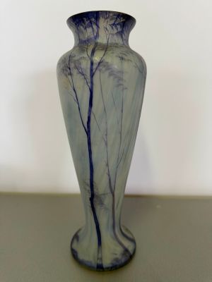 a blue and white vase sitting on a table