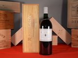 a bottle of wine sitting on a table next to wooden boxes