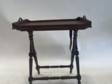 a small wooden table with a tray on top of it