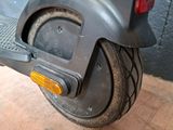 a scooter that is sitting on a wooden floor