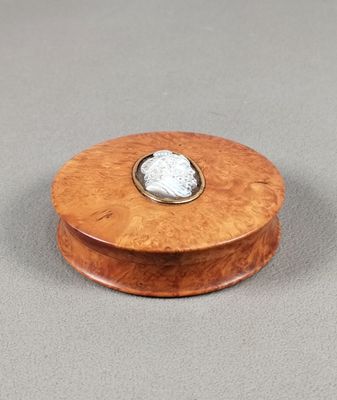 an image of a wooden box with a stone in the center