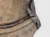a close up of a wooden vase with a bird on it