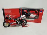a red and white motorcycle in a box next to a red and white motorcycle