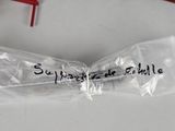 a plastic bag with writing on it sitting next to a pair of scissors