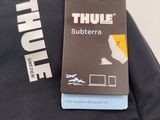a label on the back of a backpack that says thule subberra