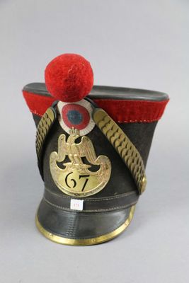 a black hat with a red pom pom on it