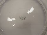 a close up view of a white plate with a green design on it