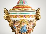 a vase with a lid that has a painting on it