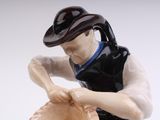 a figurine of a man with a hat and a baseball glove