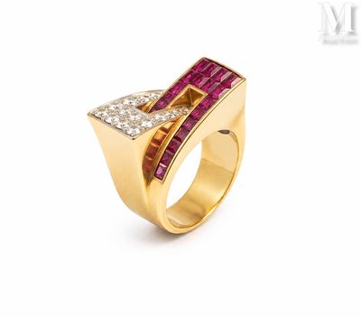 a yellow gold ring with a ruby and diamond set in the middle
