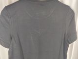 a grey cropped shirt hanging on a hanger